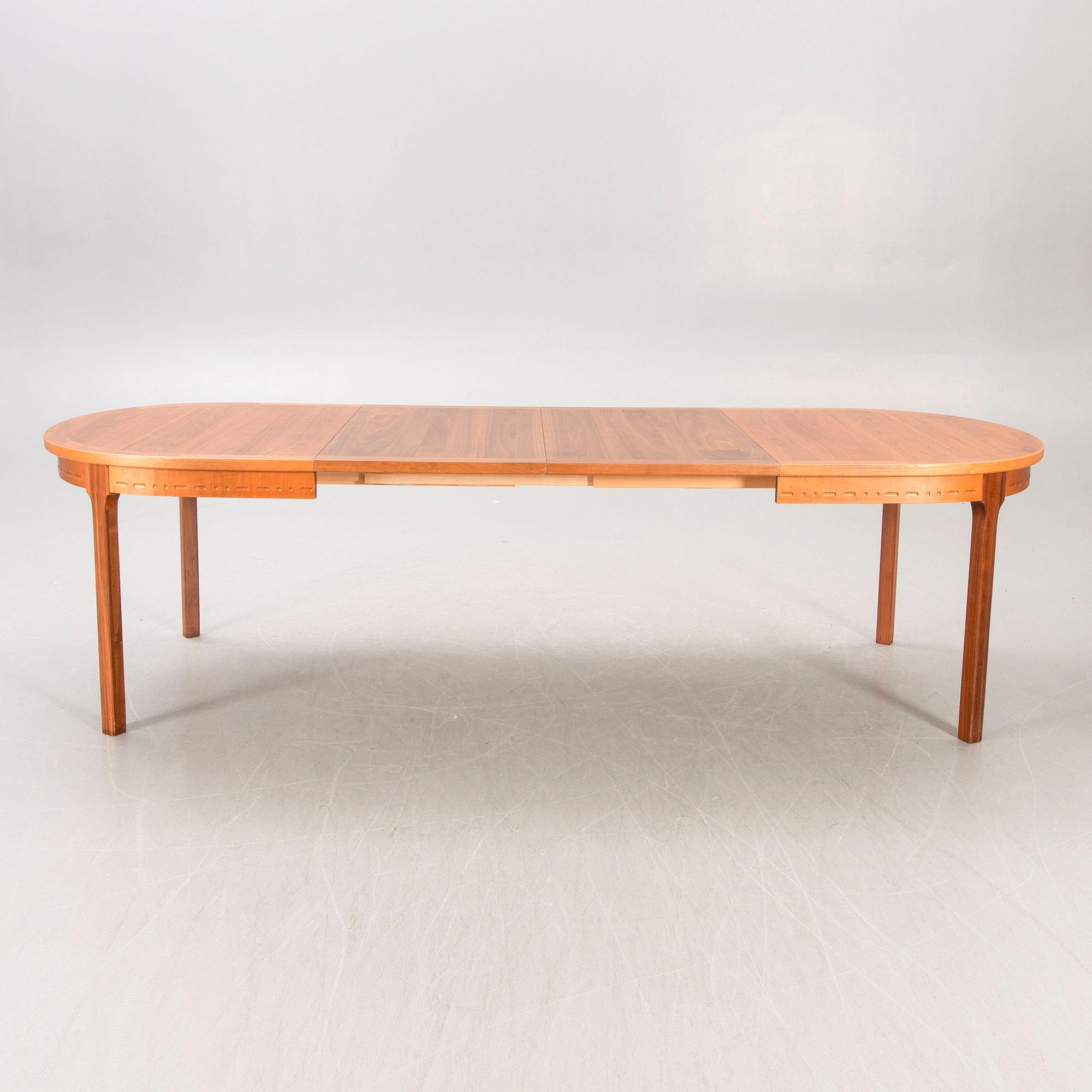 A Nils Jonsson teak and walnut 1960s dining table.