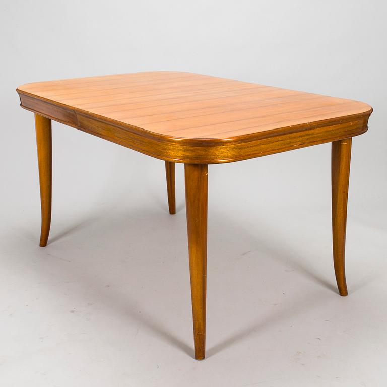 A mid 20th century dining table and a set of four chairs, Oy Boman Ab and two chairs Werner West.