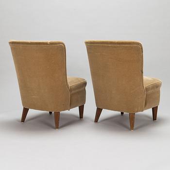 A pair of 1950s armchairs.