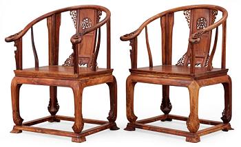 A pair of hardwood horseshoeback armchairs, late Qing dynasty, circa 1900.