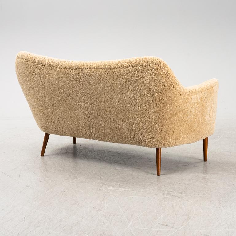 A mid 20th Century sofa with teak legs and new sheepskin upholstery, possibly by Carl Brorup, Slagelse, Denmark.