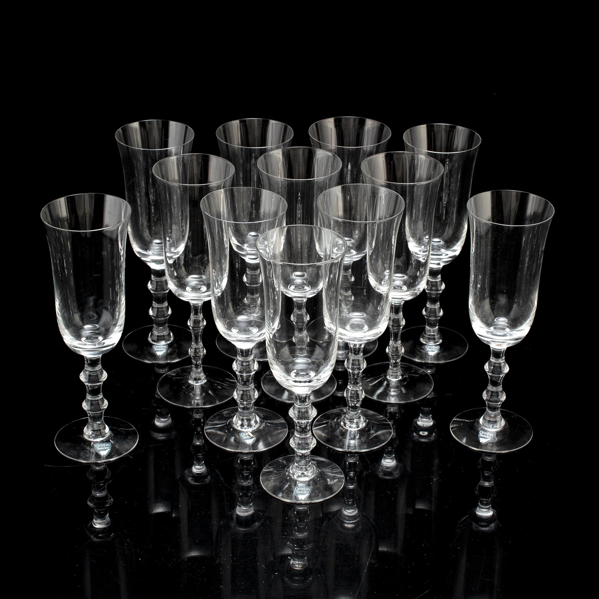A set of twelve champagne glasses by Simon Gate.