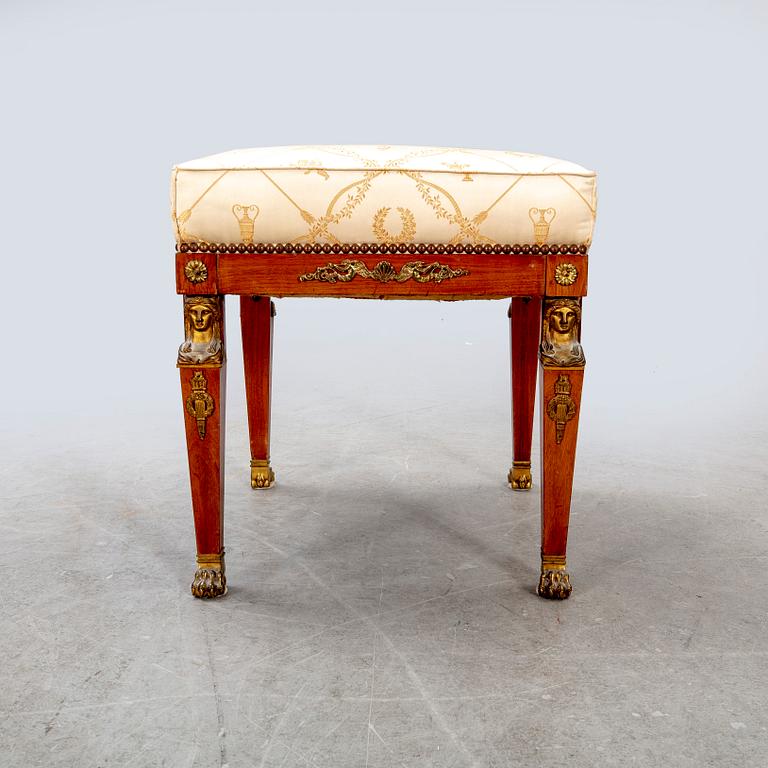 An Empire style mahogany stool around 1900.