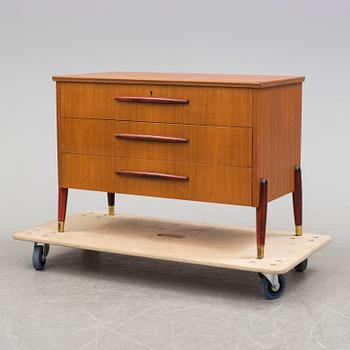 A 1950s teak veneer chest of drawers.