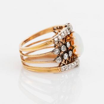 An 18K gold and platinum ring set with an opal and old- och rose-cut diamonds.