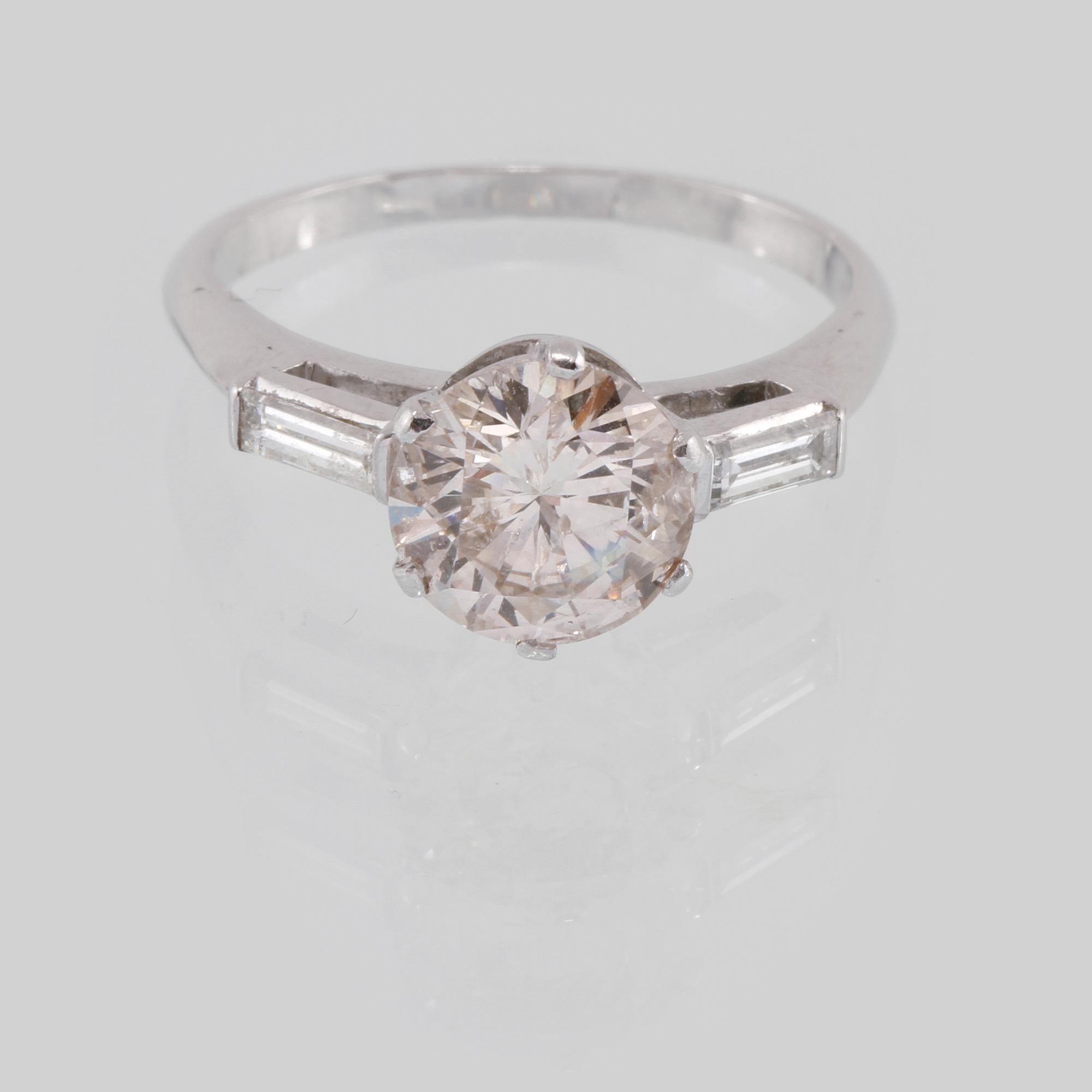 RING, platina med briljantslipade diamant 2.19 ct samt 2 baguettslipade diamanter 0.21 ct, Vikt 5,1 gram.