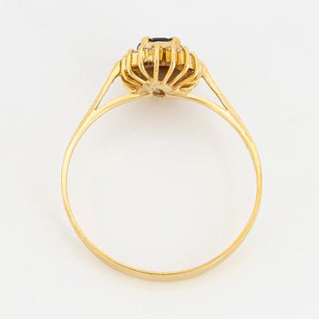 Oval mixed-cut sapphire and round brilliant-cut diamond halo ring.