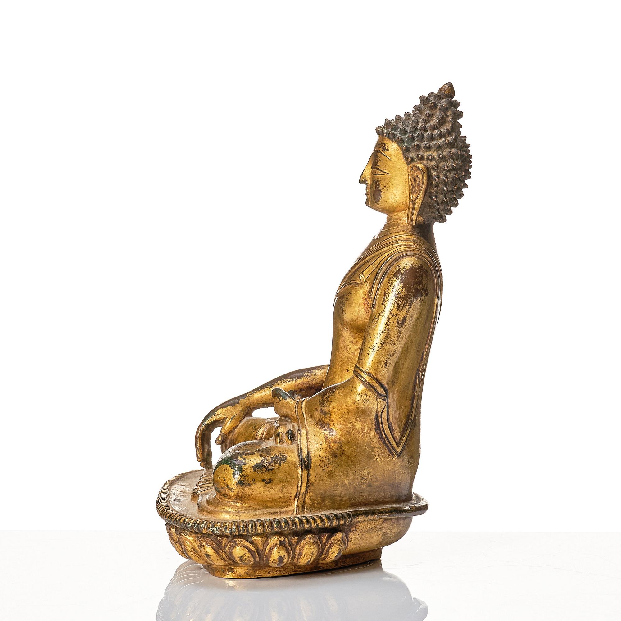 A gilt copper alloy figure of buddha, Nepal, 18th Century.