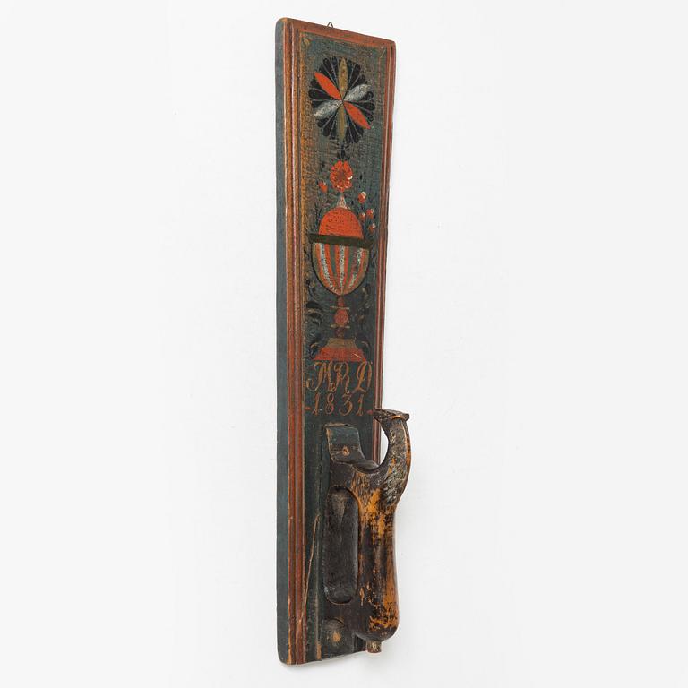 A painted wooden mangle board, dated 1831.