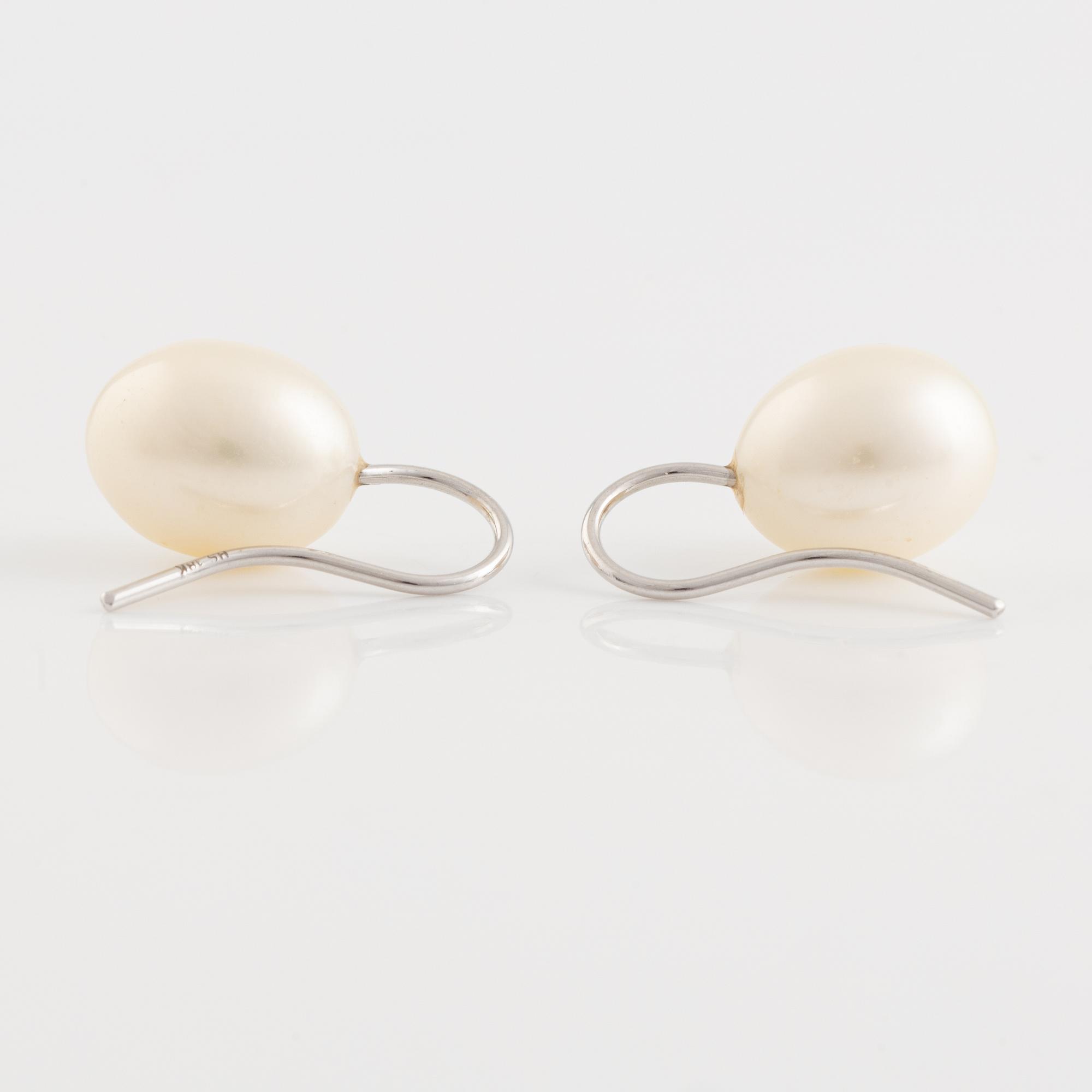 A pair of white gold earrings with cultured pearls.