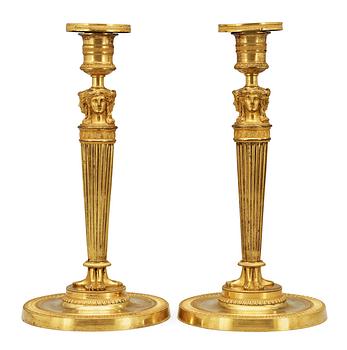 625. A pair of French Empire early 19th Century candlesticks.