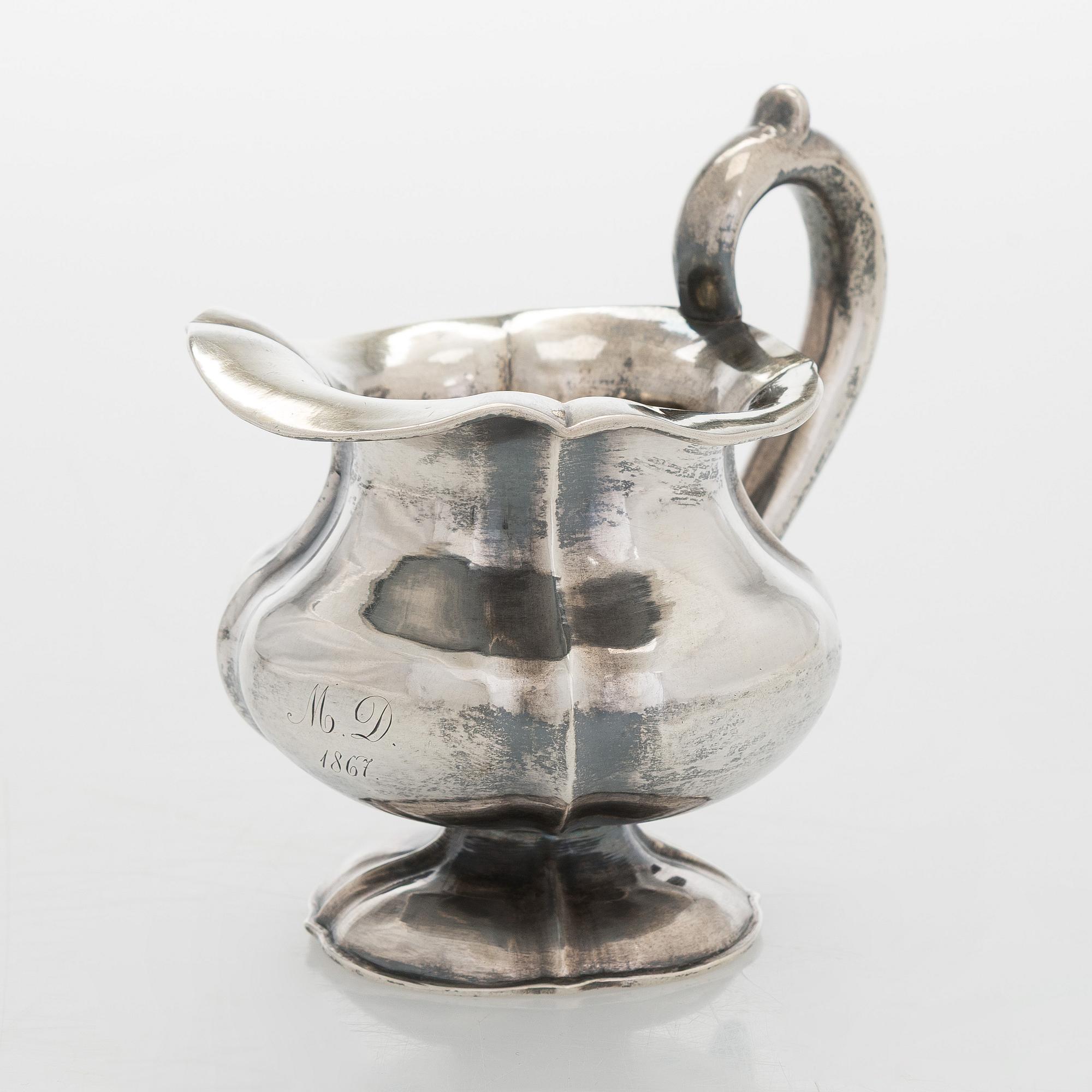 A silver cream jug, maker's mark of Michael Takkinen, St. Petersburg 1856.