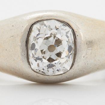 A platinum ring set with a cushion shaped old-cut diamond.