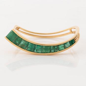 An 18K gold Lantz bracelet set with step-cut emeralds.