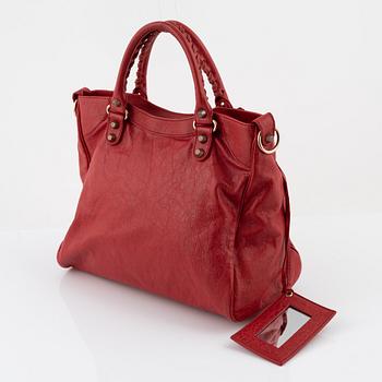 Balenciaga, a red leather 'City' bag.