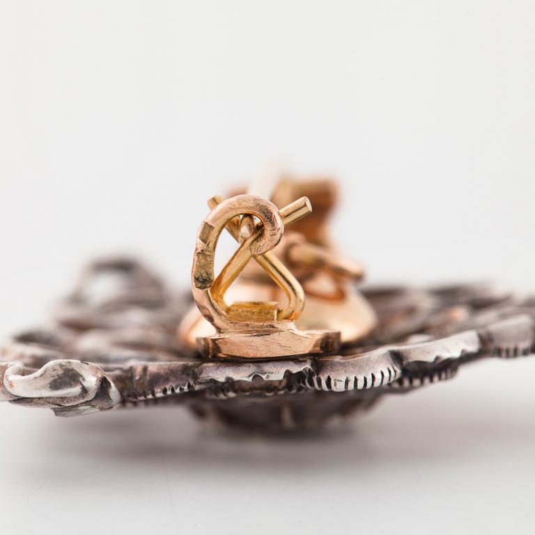 A pair of earrings and a brooch set with rose cut diamonds.