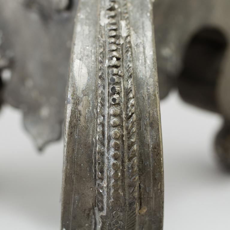 A pair of baroque pewter candlesticks, engraved date 1699.