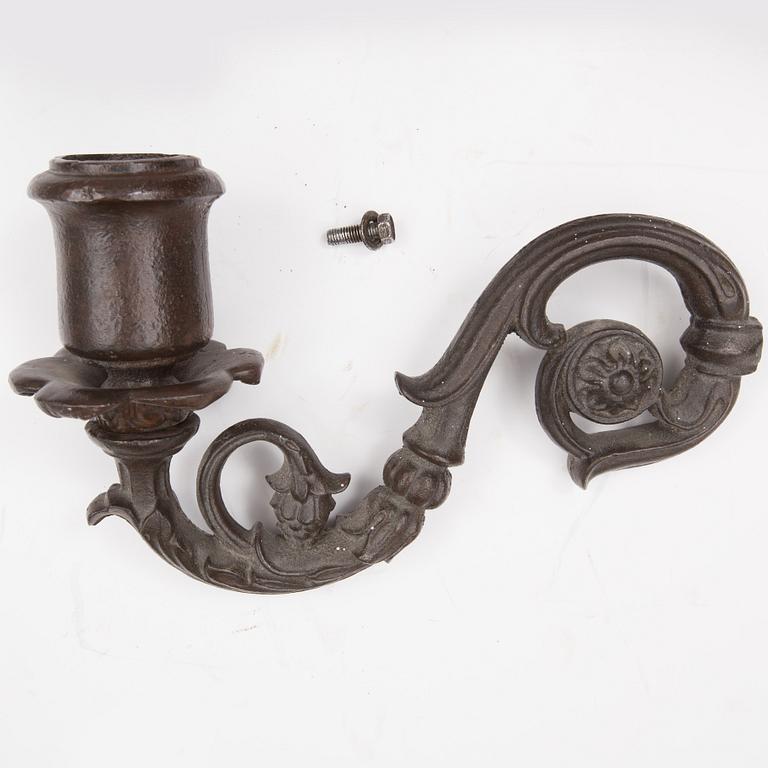 An early 20th century cast iron vall sconce candleholder for five candles.
