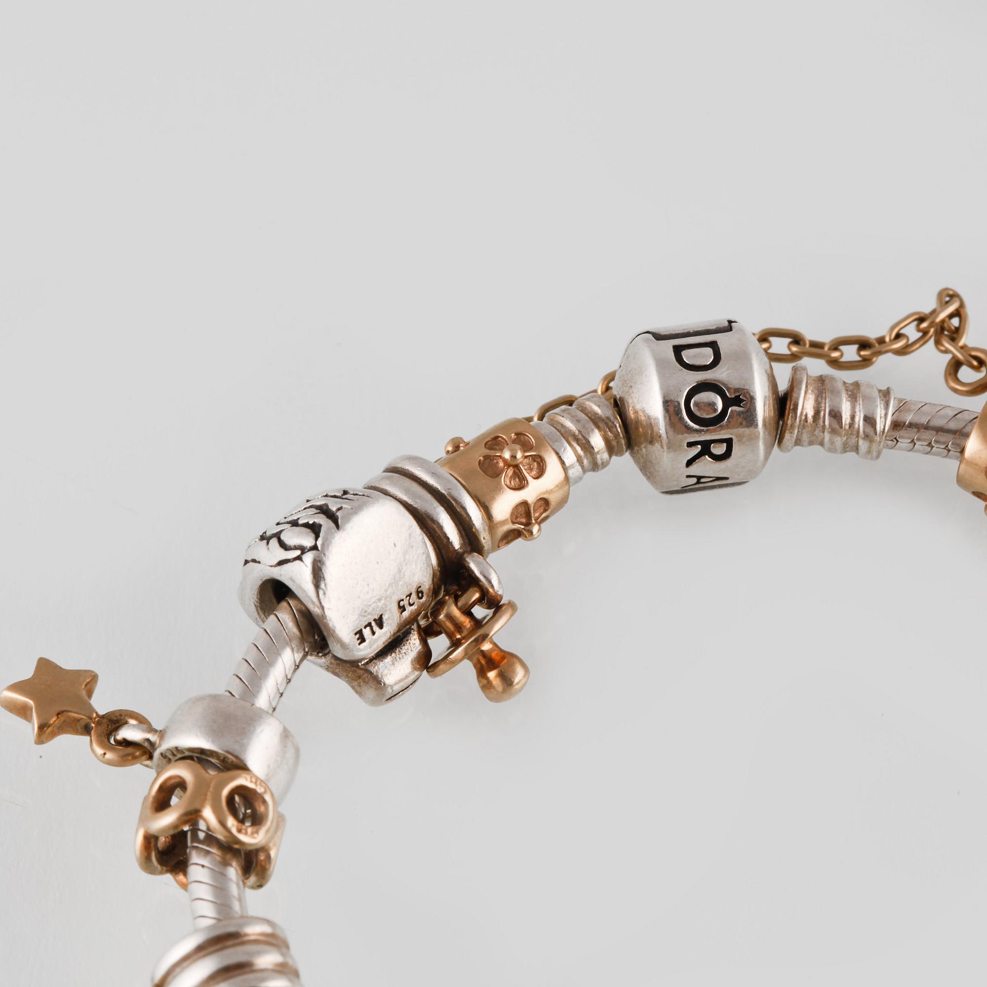 ARMBAND, silver samt guld med en briljantslipad diamant ca 0.01 ct, Pandora, Vikt 57,8 gram.