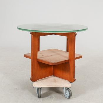 A 1940s wood and glass coffee table.