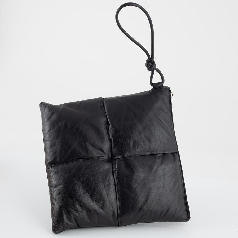 Bottega Veneta, a black leather handbag.