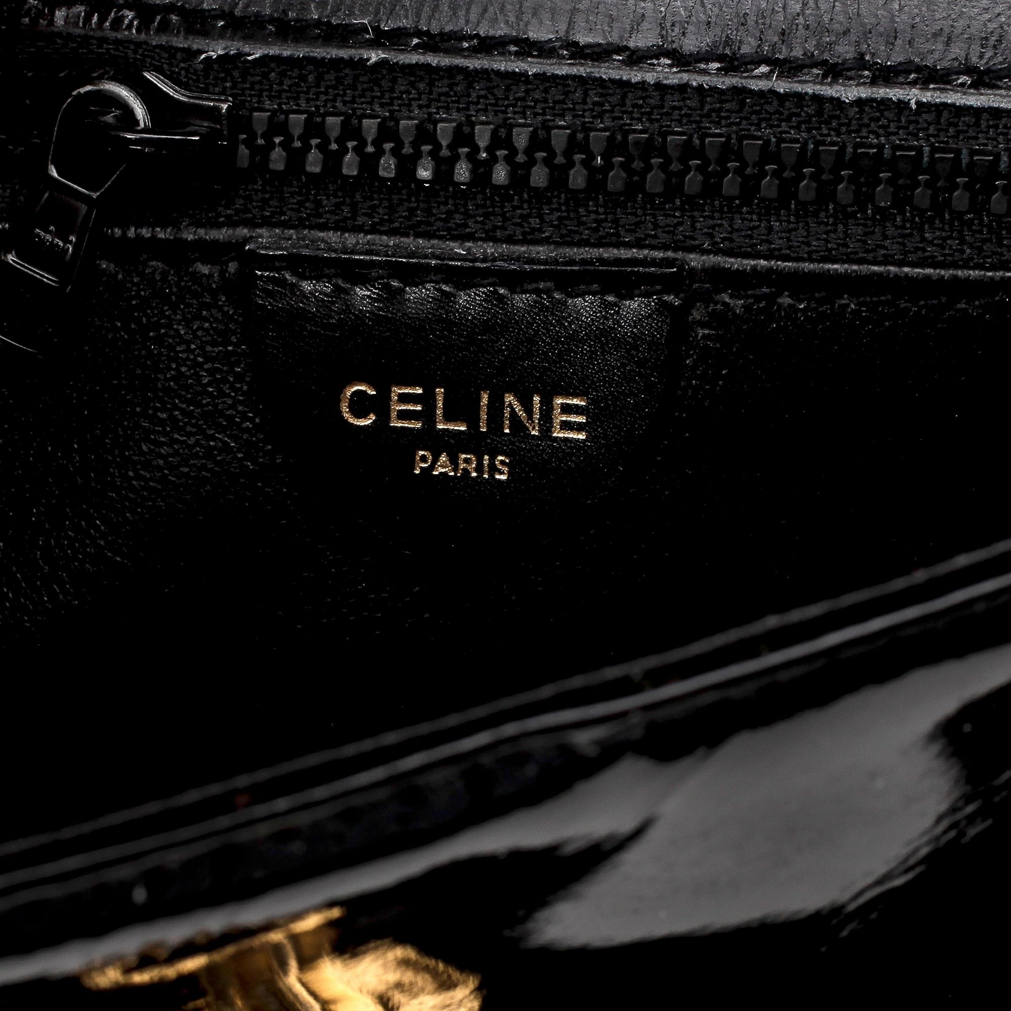 CÉLINE, a black leather patent shoulder bag.