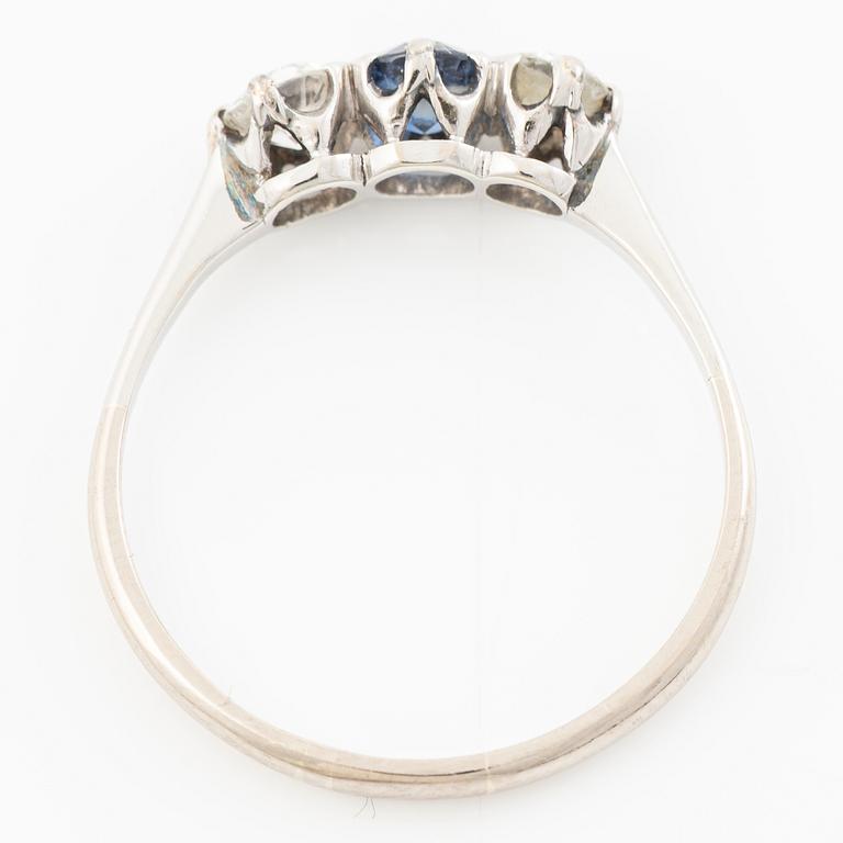18K gold ring with two old-cut diamonds and a blue stone.