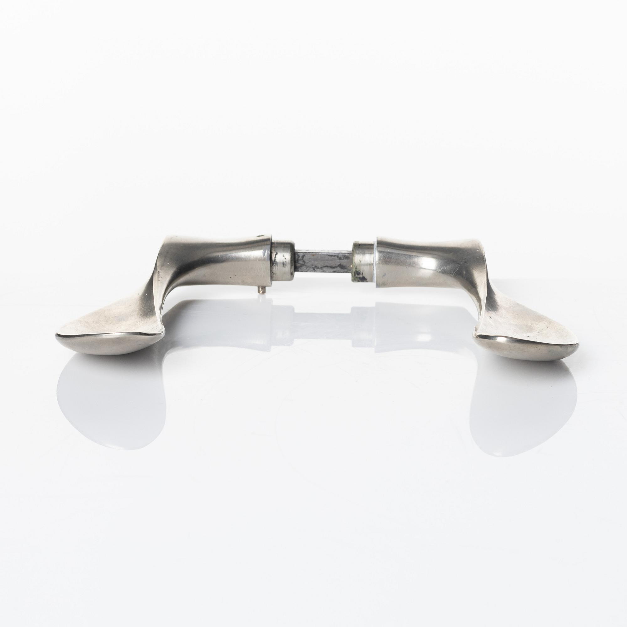 Arne Jacobsen, a door handle 'AJ-Grebet' for SAS Royal Hotel, Copenhagen 1956, executed by Carl F Petersen.