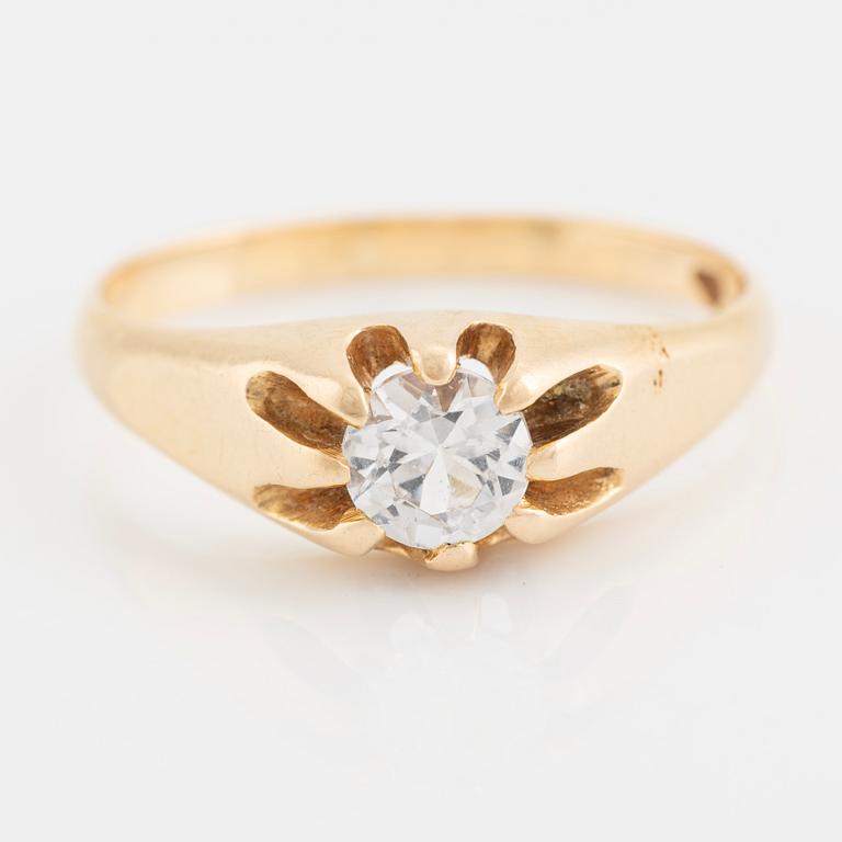 Ring, with faceted white stone.