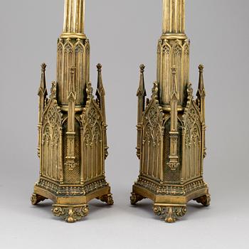 A pair of Pugin style gothic revival candlesticks, mid 19th century.