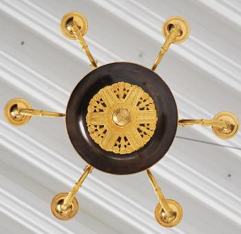 A Swedish Empire ormolu and patinated six-branch chandelier, Stockholm, early 19th century.