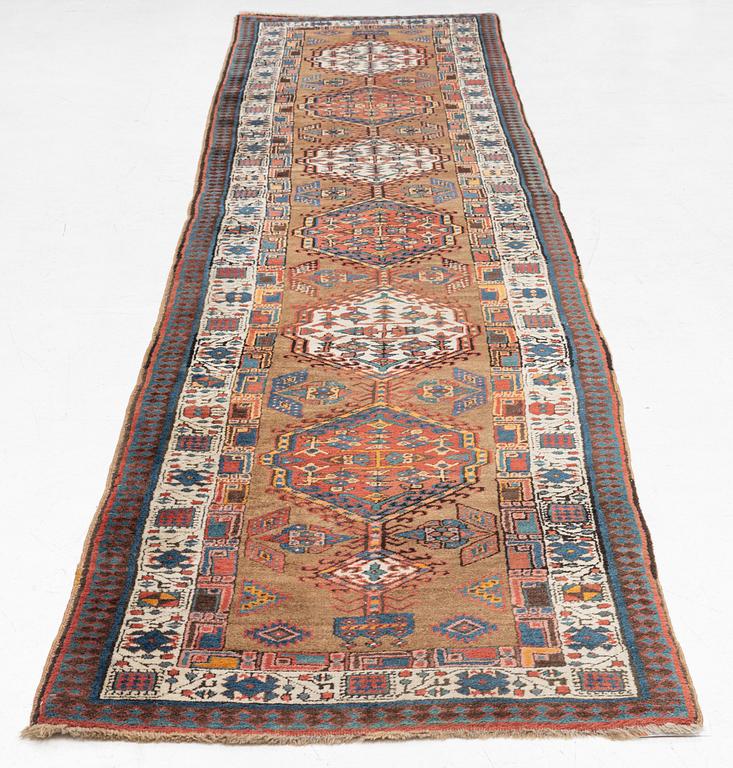 An Oriental runner, c. 430 x 95 cm.