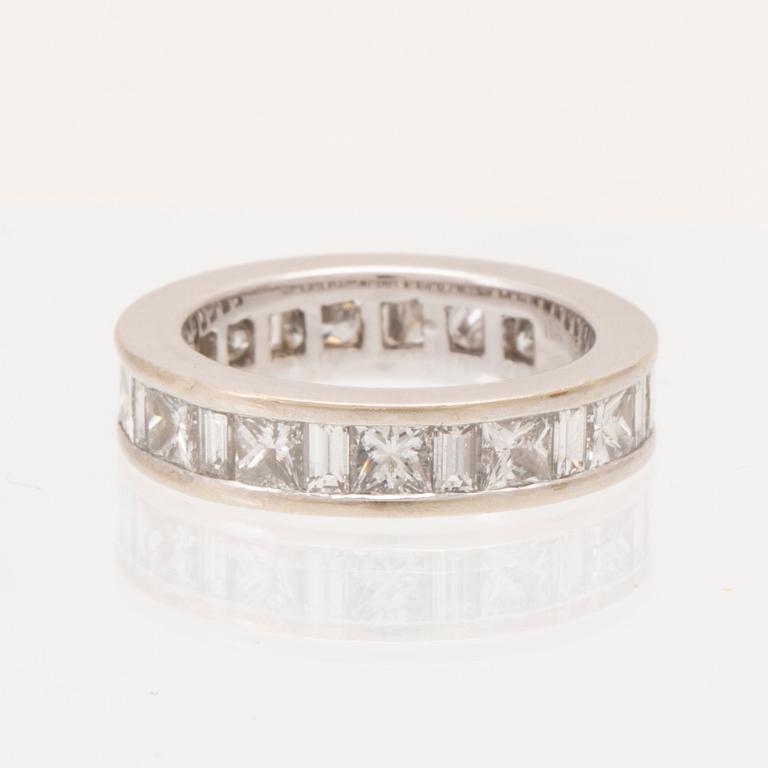 An 18K white gold eternity ring set with baguette and princess cut diamonds by Hartmann's Denmark.