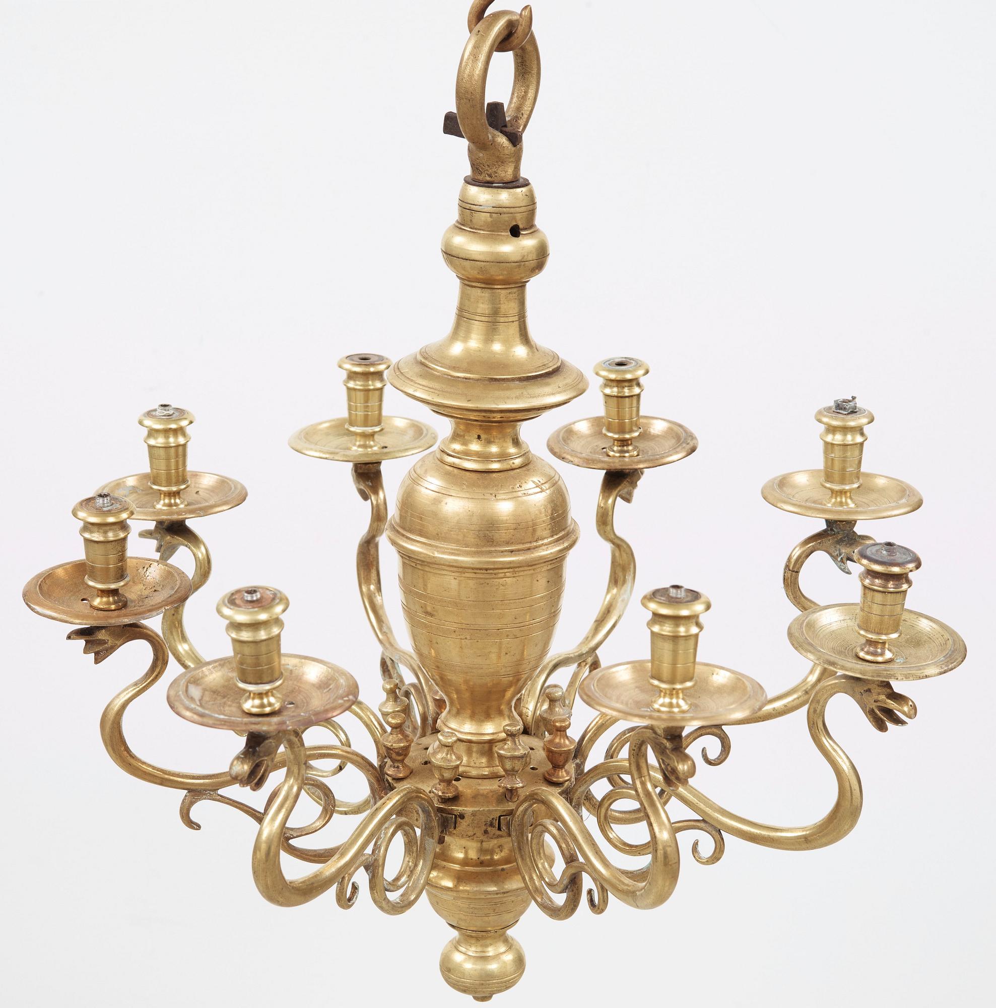 A 19th century eight-light brass chandelier in the manner of Hans Rogiers van Harelbeke.