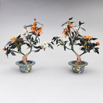 A pair of Chinese table decorations in various stones, enamelled pots. The latter half of the 20th century.