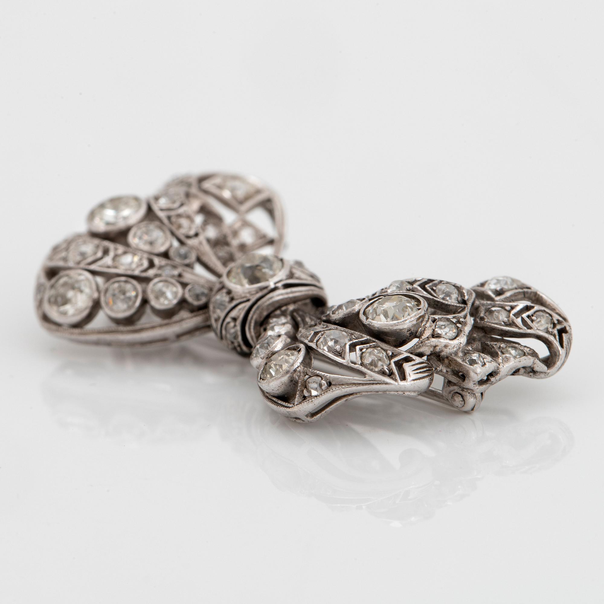 A silver bow brooch set with old-cut diamonds.