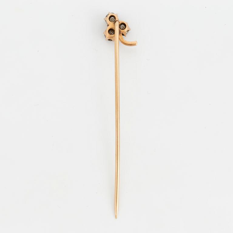 A TIE-PIN, 14K gold with three old cut diamonds.