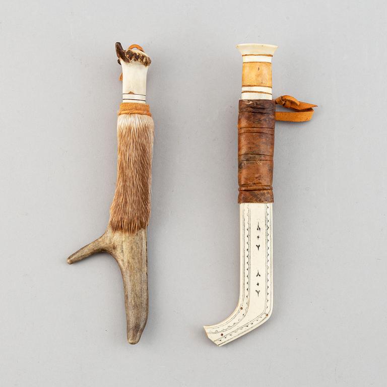 Erik Tuolja, two Sami reindeer horn, birch wood, fur and leather knives, one signed ET.