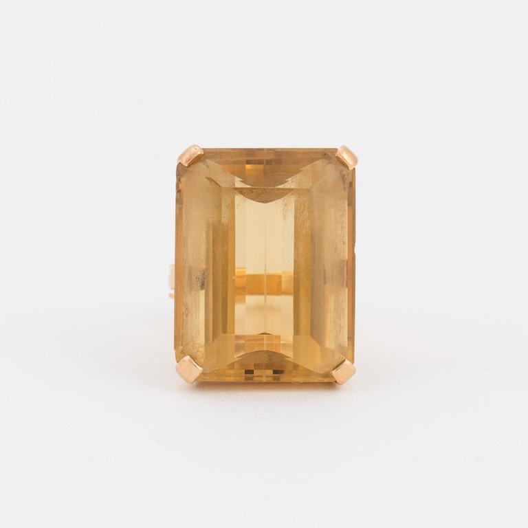 A ring set with a step-cut citrine.