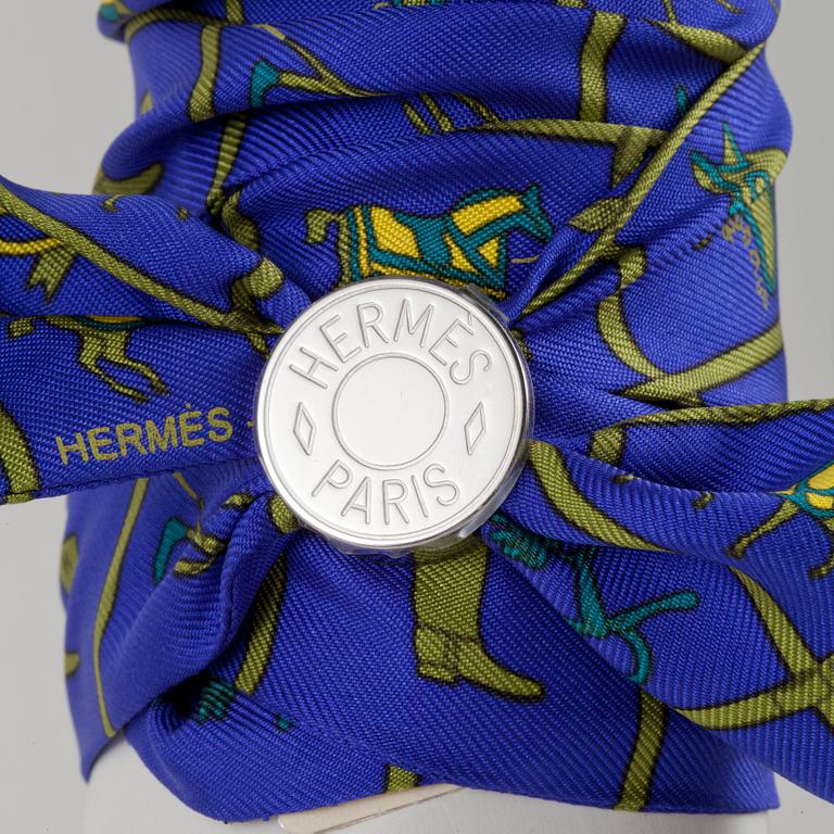 HERMÈS, two silk braclets with palladiumcovered locks.
