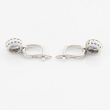 A pair of 14K gold earrings with faceted sapphires.