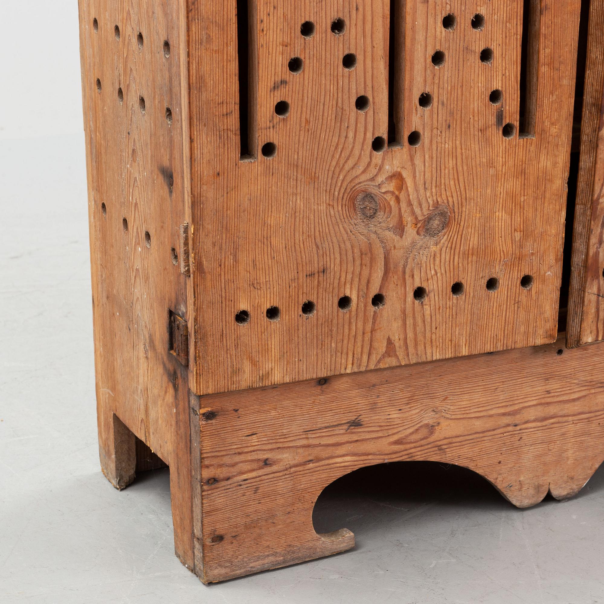 A late 19th century pine cupboard for eggs.