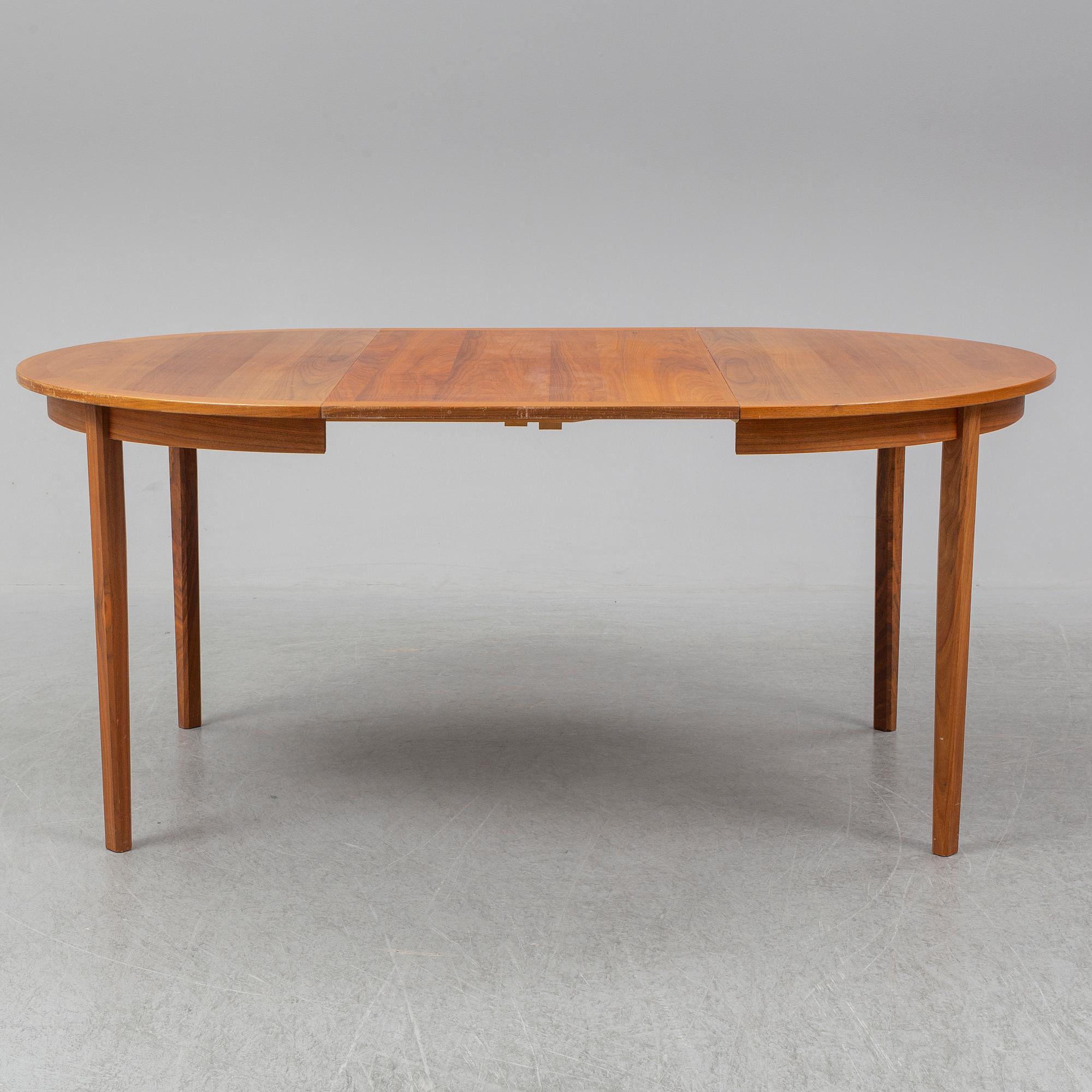 A 1950/60s teak and valnut table and four chairs.