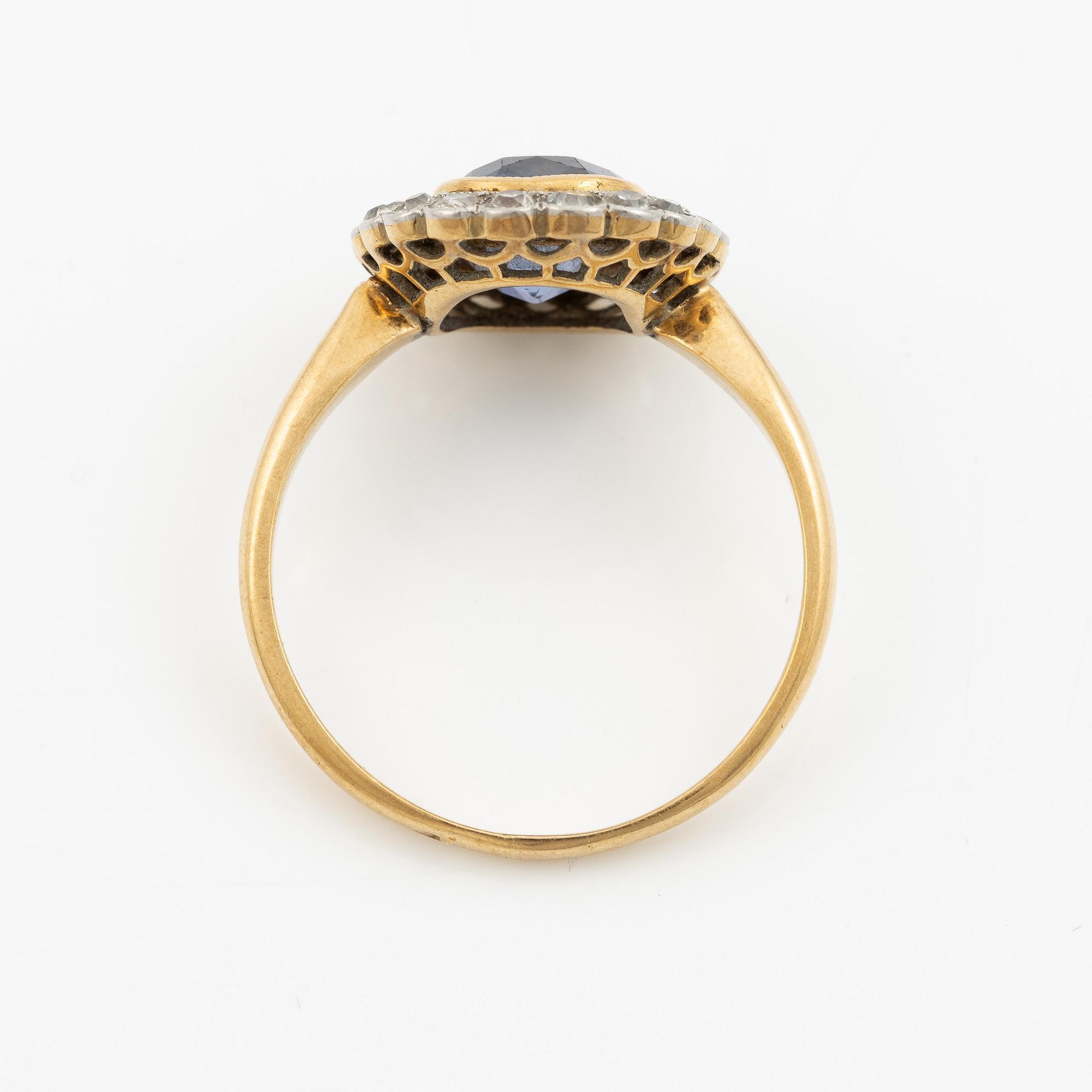 A ring in gold with a cushion-cut purple sapphire and old-cut diamonds, ca first half of the 20th century.