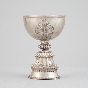 A Tibetan butter lamp, silvered copper, 20th century.