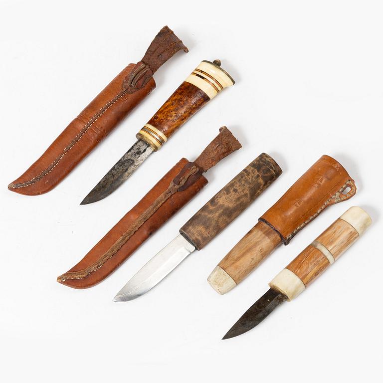 Six knives, and a cup.