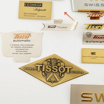 A collection of shop signs and agent plaques from Swiss watchmakers.
