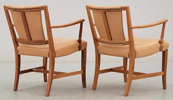 A pair of Josef Frank walnut and light brown leather armchairs, Svenskt Tenn.