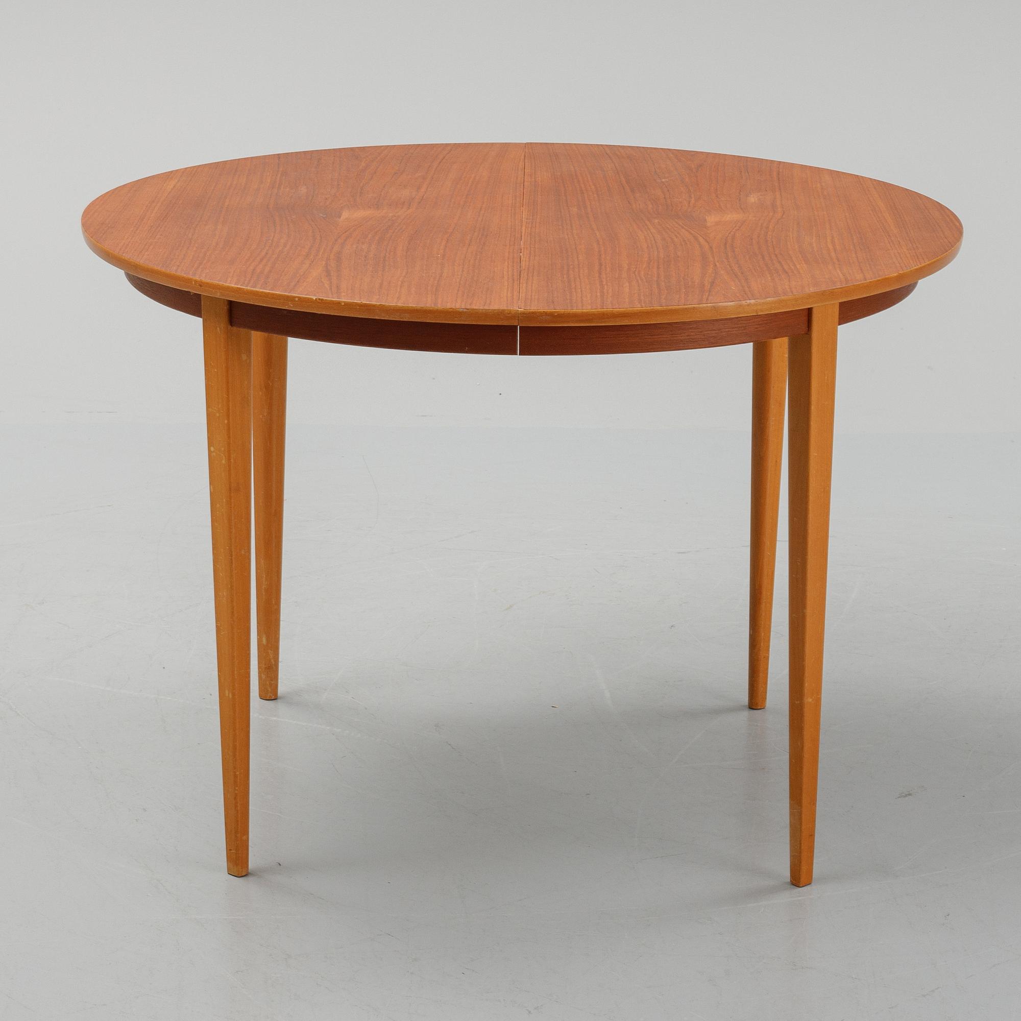A teak dining table with 4 'Monaco' chairs, mid 20th century.