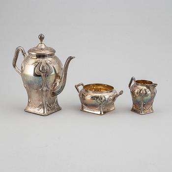 An art nouveau silver coffee pot, sugar bowl and creamer, mark of CF Källström, Malmö 1901.